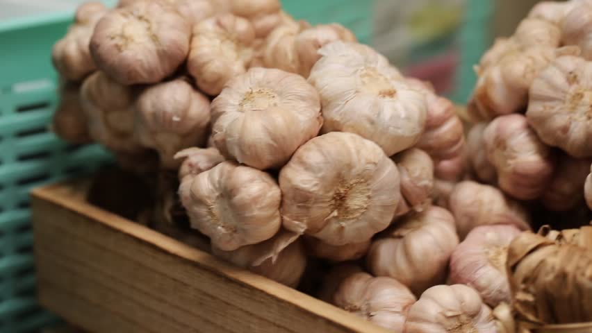 Fresh garlic in basket blur background