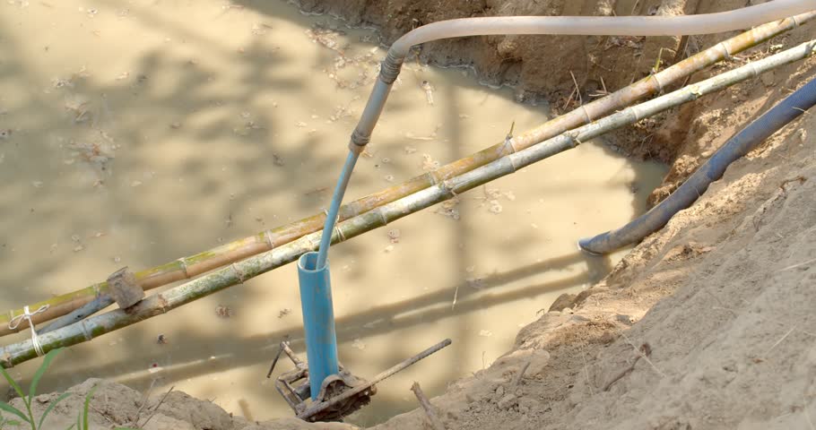 Digging an artesian well.Drilling into the soil to find water in the basement for use in the garden.Farmers search for water underground.