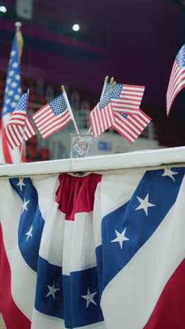 Vertical shot Table for voting registration with American flags stands at polling station. Elections in the United States of America. Presidential race and election coverage. Civic duty, patriotism