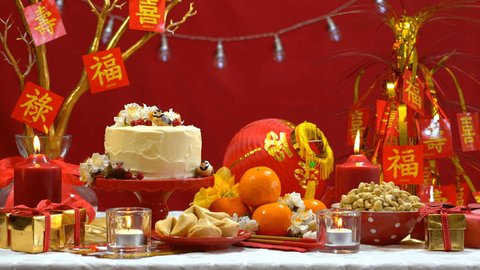 4k Chinese New Year party table in red and gold theme with food and traditional decorations Stockvideo