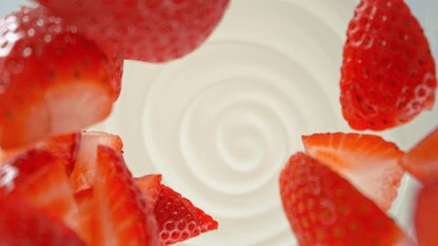 Super slow motion of strawberries falling into yoghurt cream. Filmed on high speed cinema camera with movement and rotation, 1000fps. Stock-video
