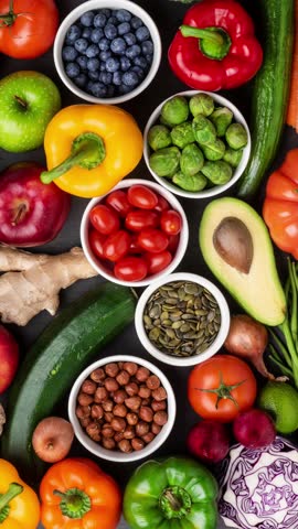 Vertical video. Healthy eating ingredients: fresh vegetables, fruits and superfood. Nutrition, diet, vegan food concept.