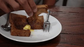 4k video footage of asian man eating Butter toast for breakfast at kopitiam. Concept for restaurant and eatery.