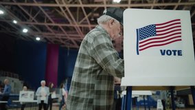 Elderly female voter with bulletin comes to voting booth. Diverse American citizens come to vote in polling station. Political races of US presidential candidates. National Election Day. Dolly shot. - Powered by Shutterstock - Get 15% off with code: PIKWIZARD15