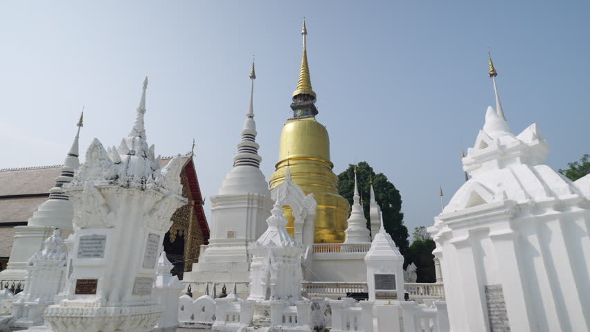 Dolly shot of golden pagoda at Suandok temple Chiangmai thailand steady cam 