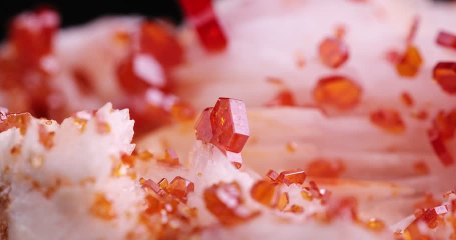 orange Vanadinite crystals rotating clip from morocco. macro photography detail texture background. close-up raw rough unpolished semi-precious gemstone 