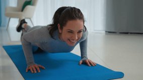 Caucasian happy strong sporty woman athlete sportswoman fit slim healthy lady female sport trainer morning workout training push ups exercise on floor yoga mat at home gym fitness girl cheerful smile - Powered by Shutterstock - Get 15% off with code: PIKWIZARD15