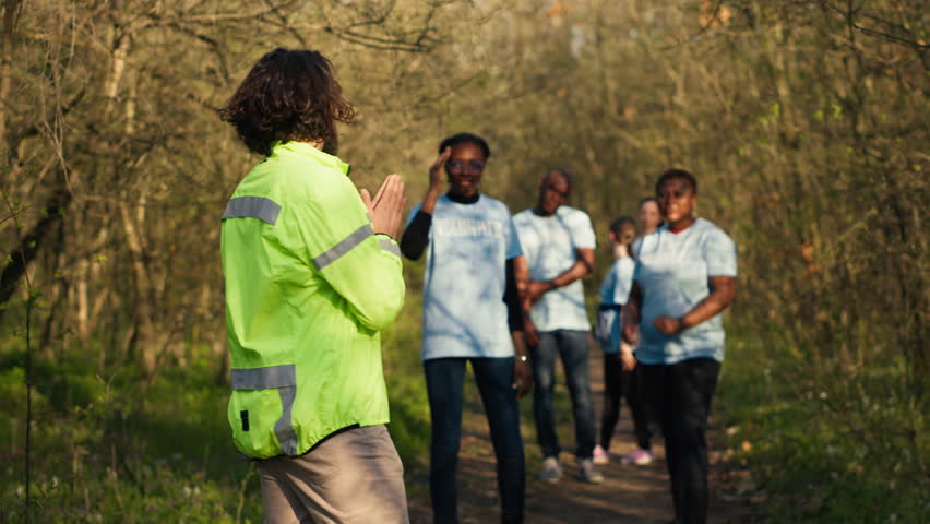 Captain of the search party directs his team through the woods to collect details during ongoing hunt for a missing person. Voices calling out for an individual's name, civil missing into the wild