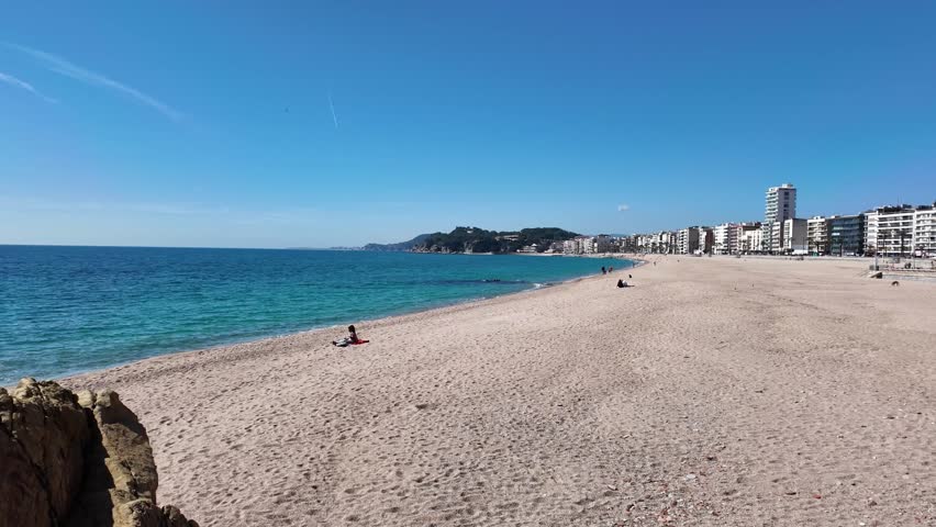 Sea view to Spanish touristic destination, coastline town Lloret de Mar, beach and buildings, 4K 