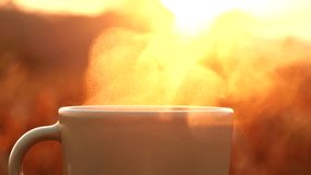 Extreme close up coffee cup nature outdoor background. Steaming hot coffee, tea cup on old wooden table against sunrise morning golden hour. Concept coffee, drink, food, breakfast, beverage, vintage - Powered by Shutterstock - Get 15% off with code: PIKWIZARD15
