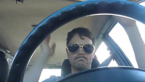 Funny clip series of model released man driving car, dancing and listening to music.