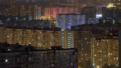 Residential district of Moscow at night. Many apartments. Lights are everywhere in the windows of houses and from street lamps. Shot from the roof of a high-rise building. Slow zoom in shot