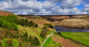  Aerial video of Naden valley higher reservoir and wind turbines at the top of the hill in Rochdale, Greater Manchester.