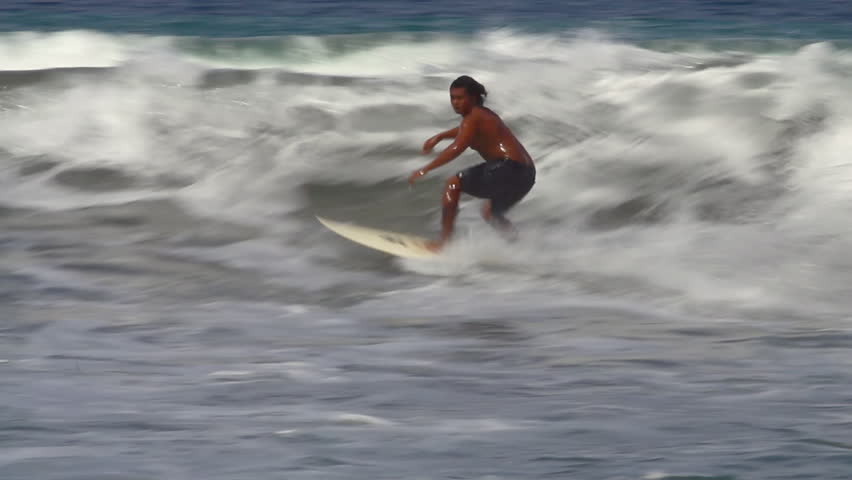 BALI, INDONESIA - DEC 25: People surfing on Kuta Beach in Bali on December 25,