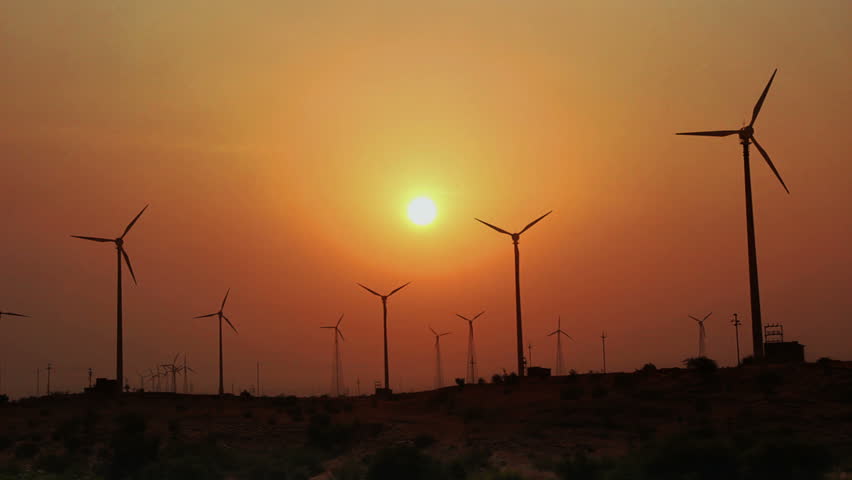 wind farm - turning windmills against timelapse sunset