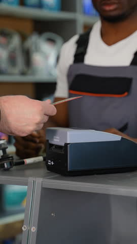 Buyer In Auto Parts Store Making Contactless Payment With Credit Card. Vertical Video