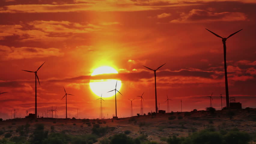 wind farm - turning windmills against timelapse sunrise