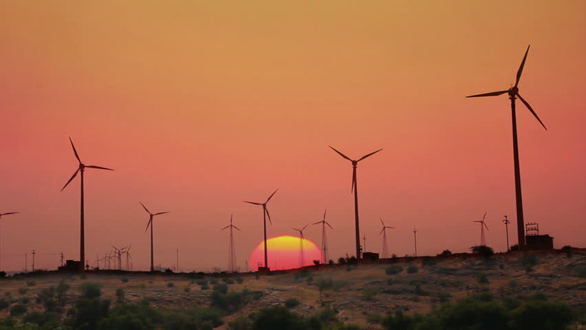 wind farm - turning windmills against timelapse sunrise