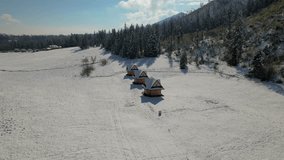 remote isolated houses at the foot of the mountains. Snow-covered houses. winter holidays
