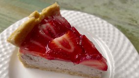 The video features a decadent cheesecake adorned with a glossy red jelly topping. Perfect combination of creamy cheesecake and vibrant, glossy raspberry or strawberry gelatin.