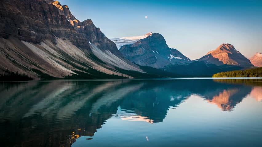 Golden Tranquility: Sunset at Bow Lake in the Canadian Rockies, Banff National Park, Alberta, Canada - Captured in Serene 4K Video Royalty-Free Stock Footage #3490641489