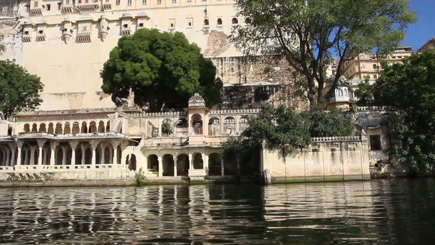 view from boat on lake and palaces in Udaipur India