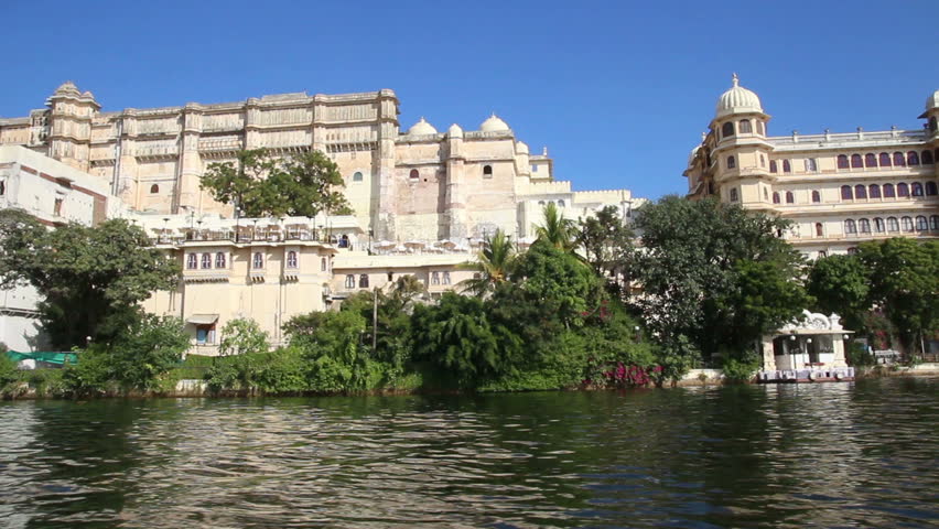 view from boat on lake and palaces in Udaipur India