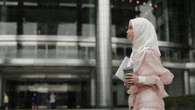 Side View of Young Beautiful Girl Walking Down Street During Coffee Break and Holding Laptop. Young Business Woman Goes Home After Work and Carries a Computer in Her Hands. People and Technology - Powered by Shutterstock - Get 15% off with code: PIKWIZARD15
