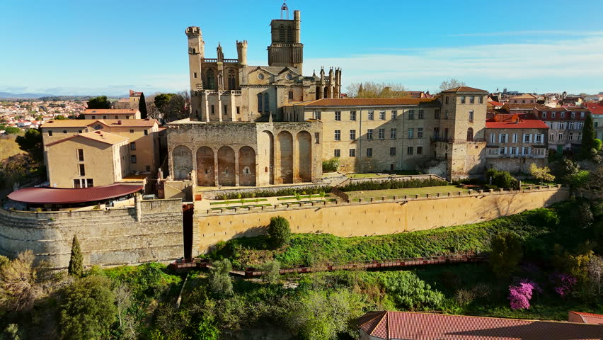 Aerial view of Beziers old town in France. The old bridge over the Orb river with the Cathedral of Saint Nazaire in Beziers, Southern France. Drone revealing footage.