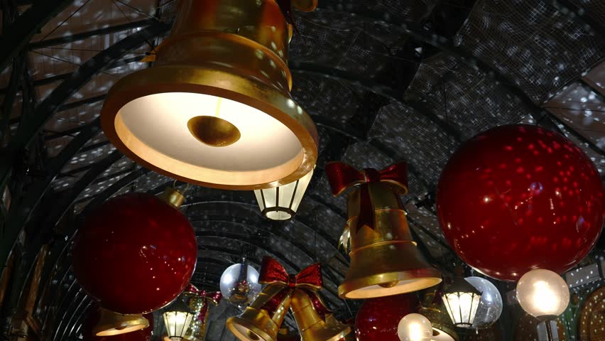 Covent Garden's popular Apple Market decorated for Christmas in London. Large bells and baubles hang from the roof. A great place to find souvenirs, jewellery, artworks, etc.