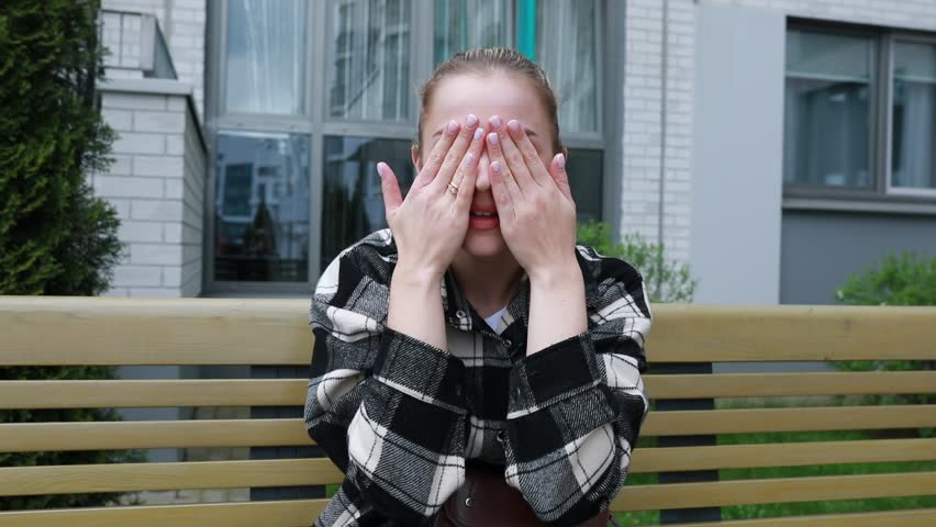 Woman Sitting on Top of Wooden Bench