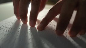 Hand of a blind person reading some braille text on page paper to learn. Finger of blind student touching the braille alphabet Code on sheet. Disabled person concept. - Powered by Shutterstock - Get 15% off with code: PIKWIZARD15