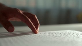 Close up hand of a blind person reading some braille text on page paper to learn. Finger of blind student touching the braille alphabet Code on sheet. Disabled person concept.  - Powered by Shutterstock - Get 15% off with code: PIKWIZARD15
