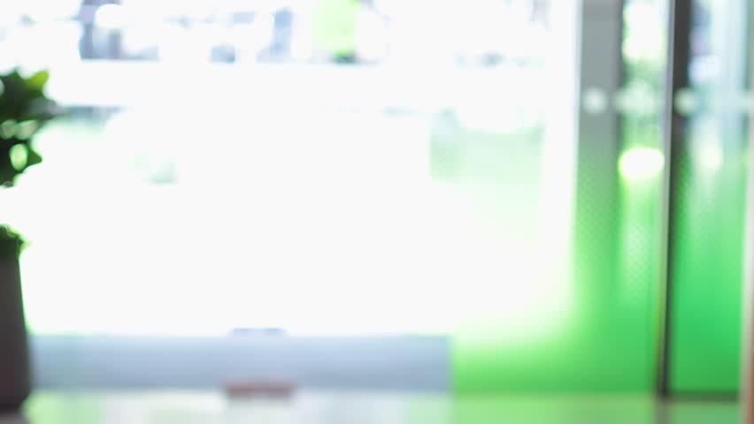 Person walking towards and exiting through sliding glass doors