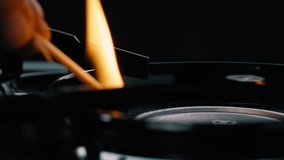 Person lighting the flame on a gas stove