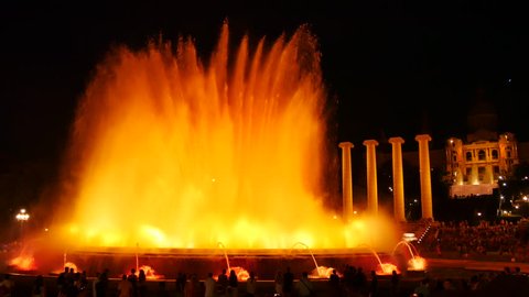 Barcelona Magic fountains attraction, a lot of tourists looking at colorful night show with different water shapes at late evening. Montjuic fontaine, Font magica de Montjuc.
