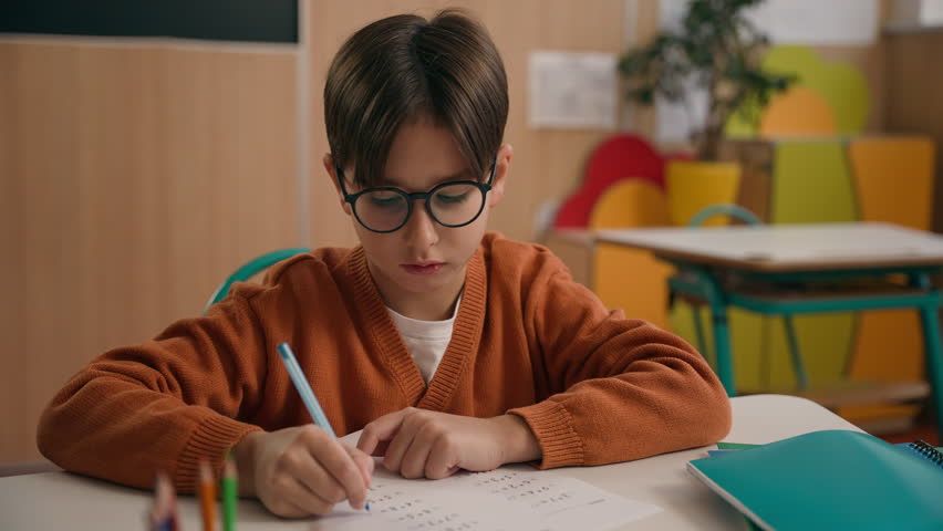 Private school course concentrated talking boy primary elementary learn schoolboy Caucasian son kid child pupil learner at class lesson studying writing task homework answer teacher education study - Powered by Shutterstock - Get 15% off with code: PIKWIZARD15