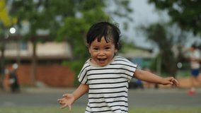 slow-motion of happy toddler girl running on grass field in the park - Powered by Shutterstock - Get 15% off with code: PIKWIZARD15