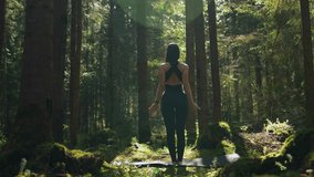 A young woman does yoga and meditates in the forest. Yoga and meditation concept. Yoga asanas. 4K - Powered by Shutterstock - Get 15% off with code: PIKWIZARD15