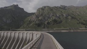Aerial Drone footage view of Fedaia Dam in Dolomites in Italy // no video editing
