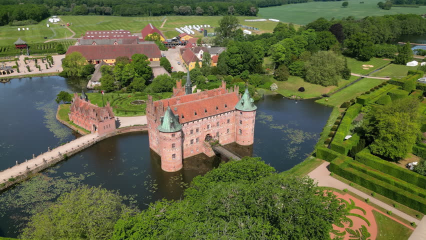 Kværndrup, Denmark: Aerial view of Egeskov Castle (Egeskov Slot), summer sunny day with blue sky - landscape panorama of Europe from above
