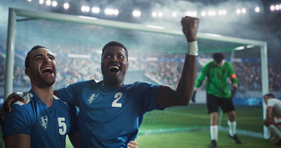 Professional Goalkeeper Failing to Block the Goal From an Attacker. Joyful Soccer Team Members Excited About the Win, Celebrating a Long Awaited Victory Against the Competitors