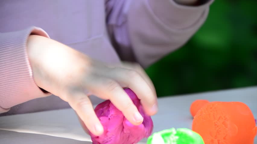 kids play with clay molding shapes, learning through play. Plasticine. dough for play. Girl molding modeling clay. Homemade clay. children's creativity, early development, fine motor skills.