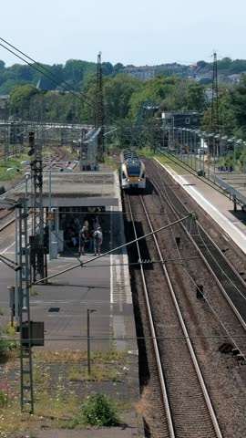 Arrival of a regional passenger train at Wuppertal-Oberbarmen station. View from above. Royalty-Free Stock Footage #3491320059