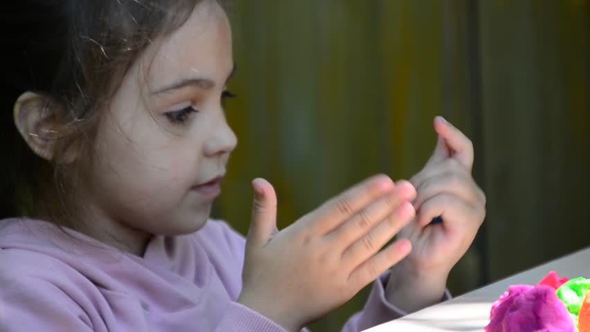 kids play with clay molding shapes, learning through play. Plasticine. dough for play. Girl molding modeling clay. Homemade clay. children's creativity, early development, fine motor skills.