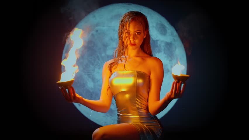 fantasy woman fashion model posing holding fire flame in hands, sexy lady fairy girl goddess priestess, night sky magic moon light, art portrait beauty face close-up lips eyes. wet blond hair video 4k