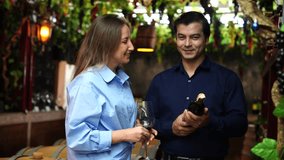 Couple, boyfriend and girlfriend come to visit wine tasting, customers purchase wine from haute barrels and tasting red wine, happy drinking wine in factory - Powered by Shutterstock - Get 15% off with code: PIKWIZARD15