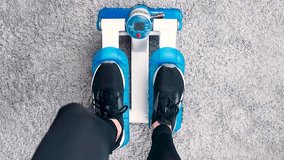Home fitness, woman doing exercises on a stepper at home close up video footage top view