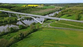Viaduct over Mayenne river in Chateau Gontier countryside, France. Aerial orbiting