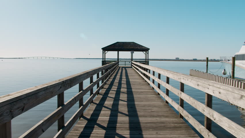 Walking to End of Pier over Glassy Clear Harbor
